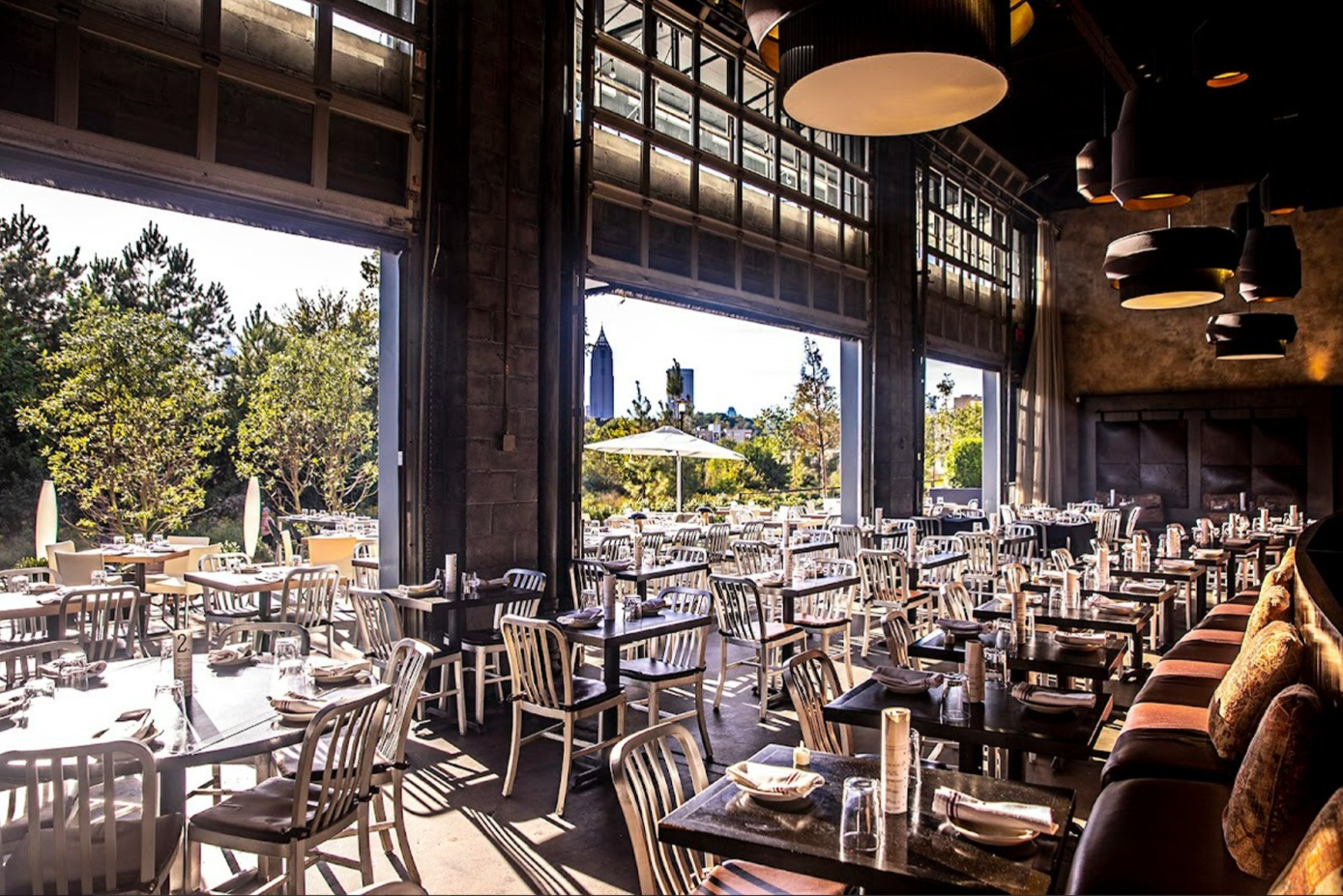 Open-air patio dining with Atlanta skyline view