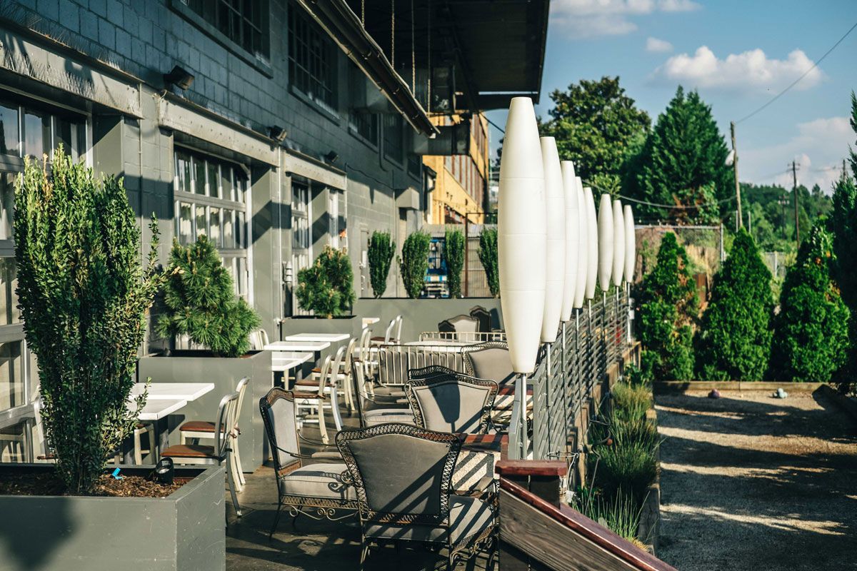 Side patio with vintage chairs and topiaries